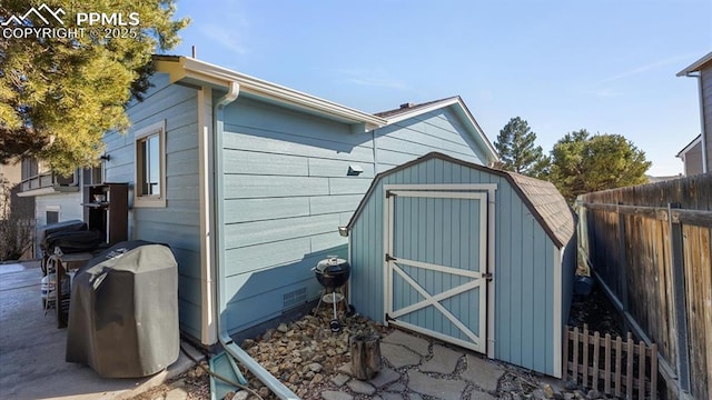 view of shed featuring fence