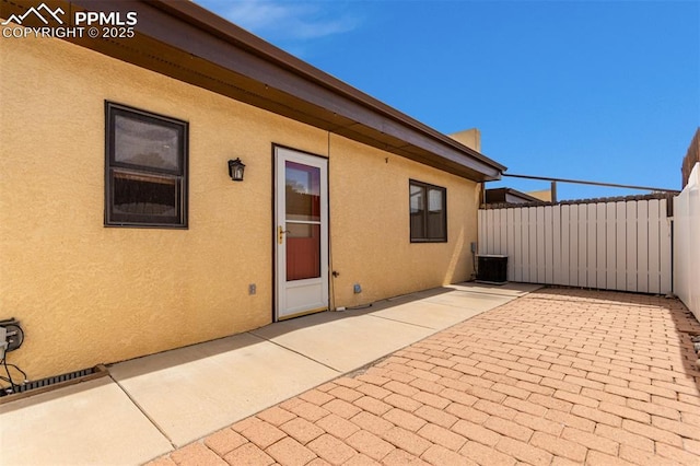 view of patio / terrace featuring central AC unit and fence