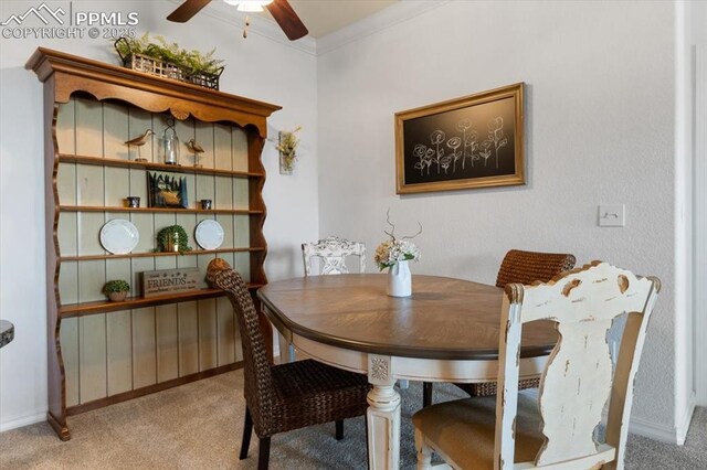 dining area featuring carpet floors, crown molding, and ceiling fan