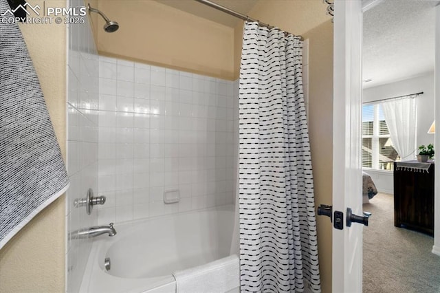 bathroom featuring shower / tub combo and a textured ceiling