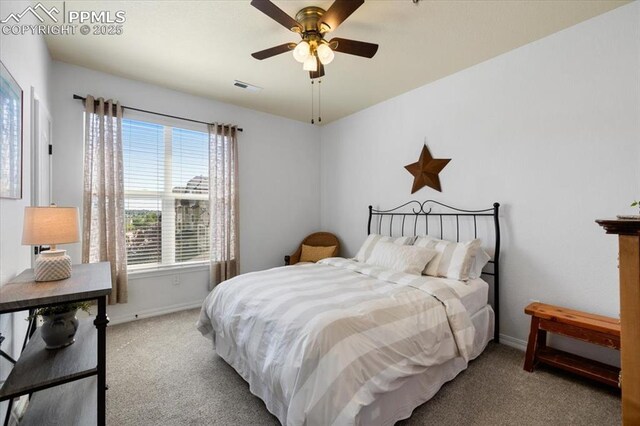 carpeted bedroom with baseboards, visible vents, and ceiling fan