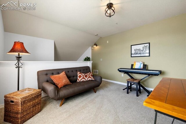 living area with lofted ceiling, visible vents, baseboards, and carpet flooring