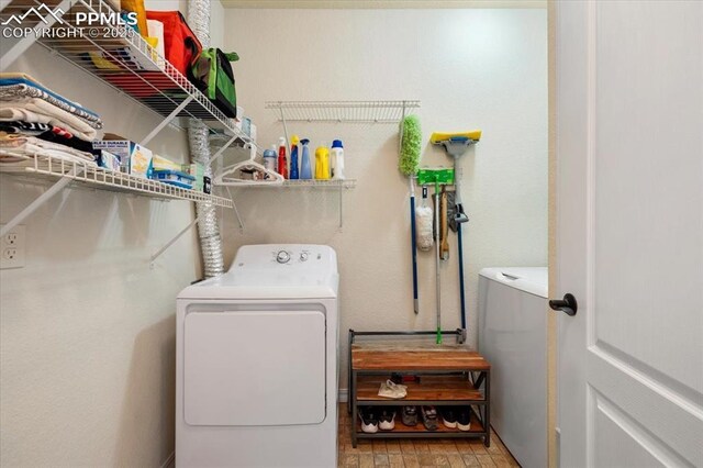 laundry area featuring laundry area and washing machine and clothes dryer