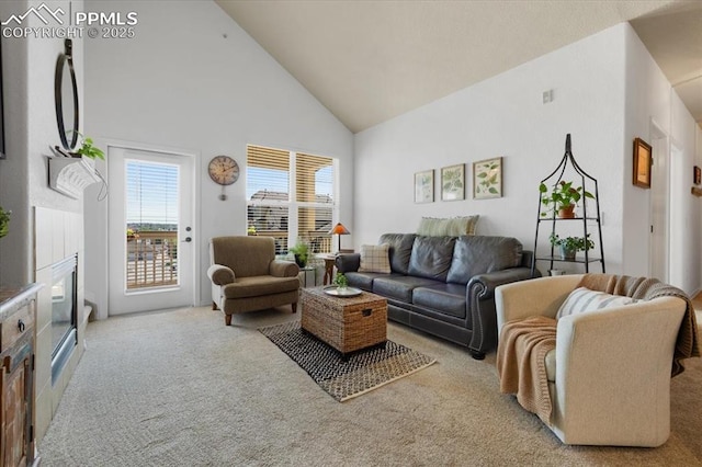 carpeted living room featuring high vaulted ceiling