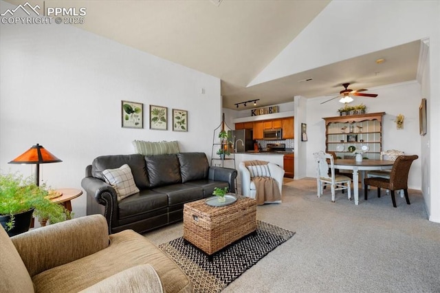 living room featuring high vaulted ceiling, light carpet, and a ceiling fan