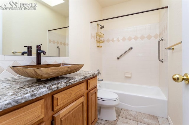 full bath featuring vanity, toilet, backsplash, and shower / washtub combination