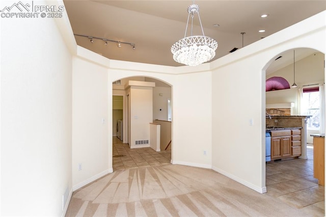 unfurnished room featuring recessed lighting, visible vents, light carpet, and arched walkways