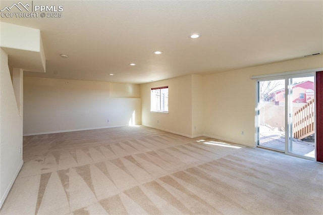 unfurnished room featuring recessed lighting, light colored carpet, visible vents, and baseboards