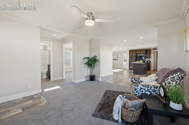 living area with baseboards, light colored carpet, ceiling fan, ornamental molding, and recessed lighting