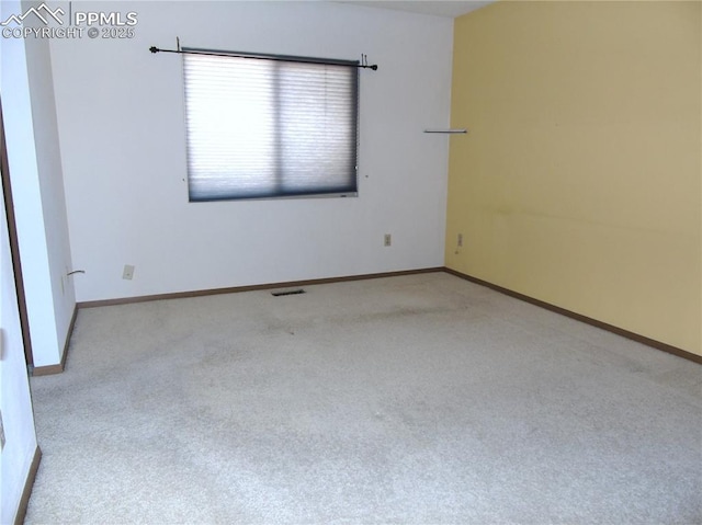 unfurnished room with visible vents, baseboards, and carpet floors