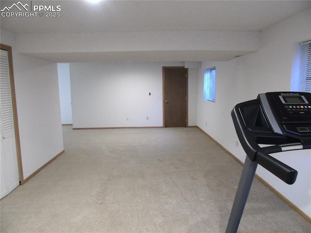 exercise room with baseboards and carpet