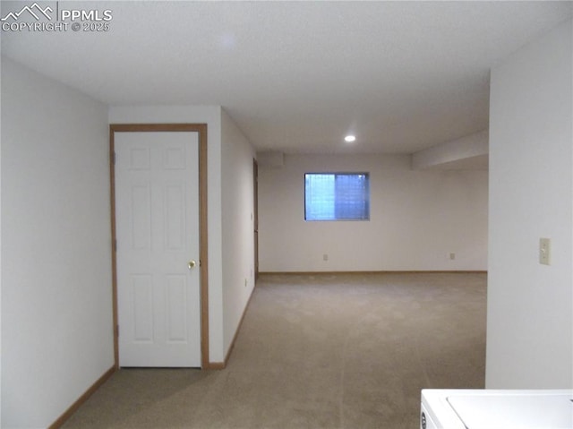 unfurnished room featuring recessed lighting, baseboards, carpet, and washer / dryer