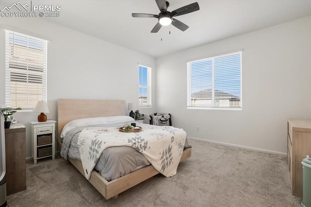 bedroom with ceiling fan, baseboards, and carpet flooring