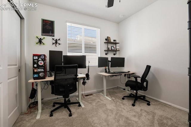 carpeted office featuring baseboards