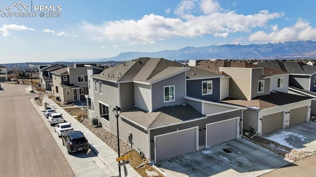 drone / aerial view featuring a mountain view and a residential view