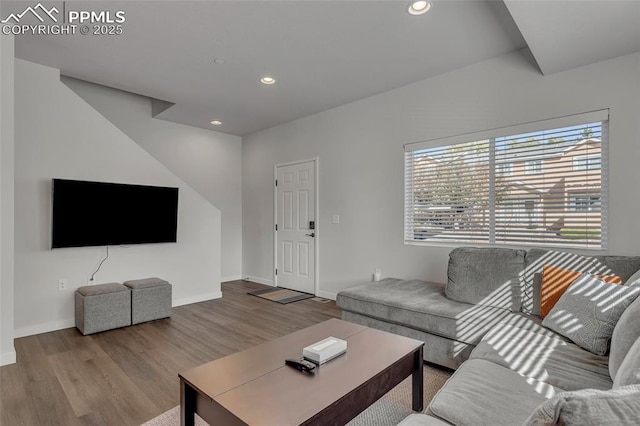 living area with recessed lighting, baseboards, and wood finished floors