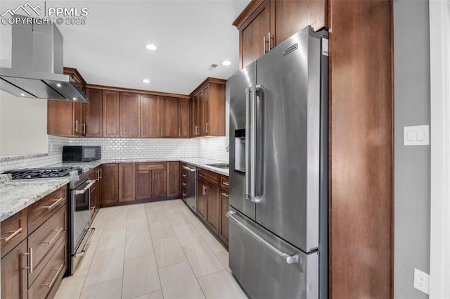 kitchen featuring light stone counters, recessed lighting, stainless steel appliances, extractor fan, and backsplash