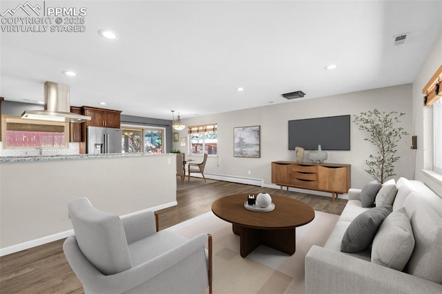 living area featuring dark wood finished floors, recessed lighting, baseboards, and baseboard heating