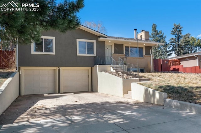 ranch-style house featuring stucco siding, driveway, fence, an attached garage, and a chimney