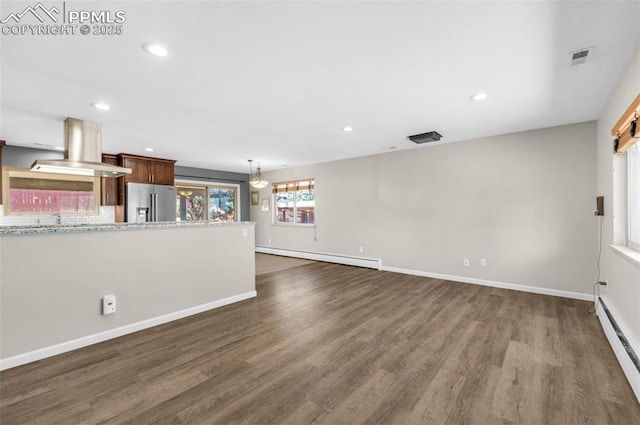 unfurnished living room with a baseboard radiator, baseboards, and dark wood-style flooring