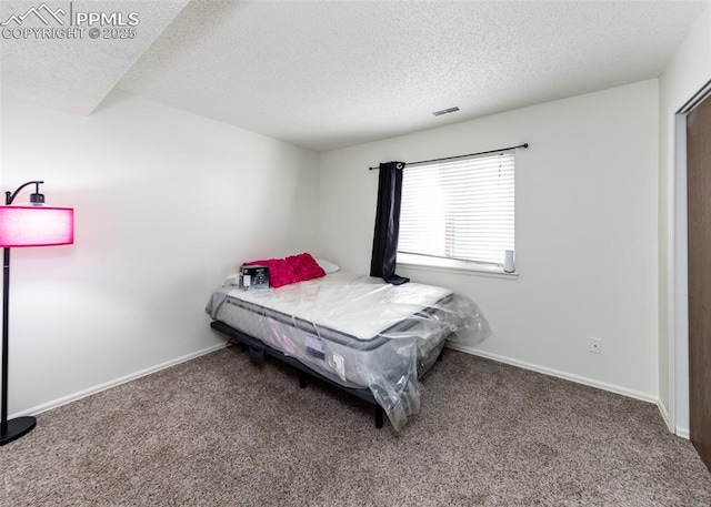 bedroom with carpet floors, visible vents, and baseboards