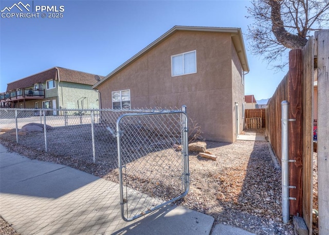 view of property exterior with fence private yard and stucco siding