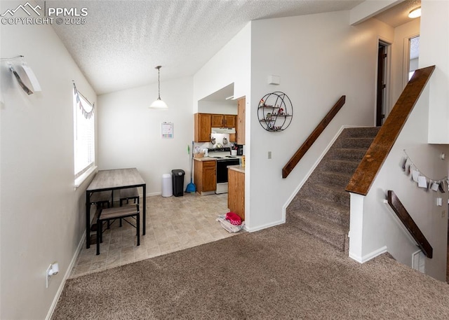 997 Magnolia St, Colorado Springs, CO 80907 - interior space featuring brown cabinets, range with electric cooktop, under cabinet range hood, lofted ceiling, and light colored carpet