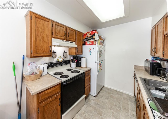 997 Magnolia St, Colorado Springs, CO 80907 - kitchen featuring white appliances, brown cabinetry, light countertops, and under cabinet range hood