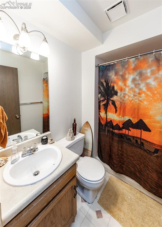 997 Magnolia St, Colorado Springs, CO 80907 - full bathroom with visible vents, toilet, a shower with shower curtain, tile patterned flooring, and vanity