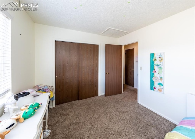 997 Magnolia St, Colorado Springs, CO 80907 - carpeted bedroom with a closet, a textured ceiling, and attic access