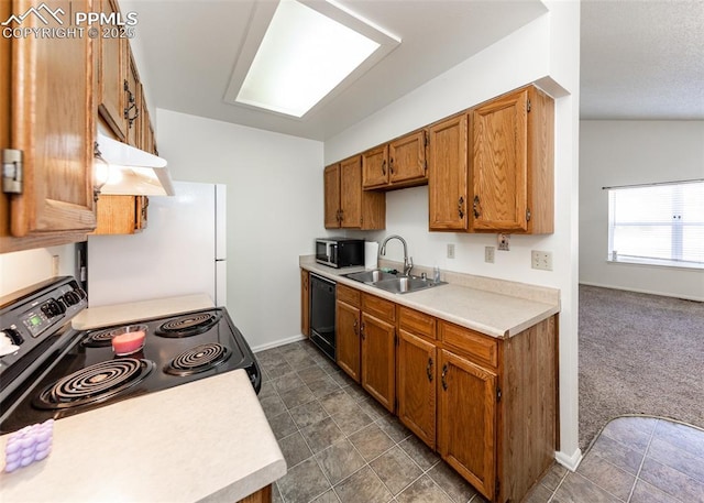 kitchen featuring under cabinet range hood, dark colored carpet, a sink, light countertops, and black appliances