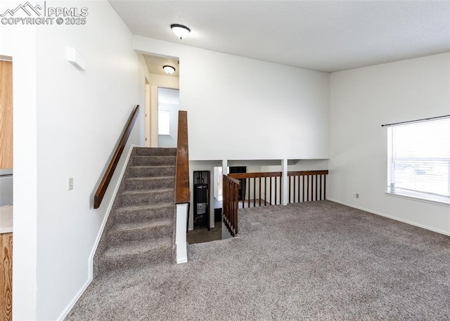 stairs featuring carpet floors, water heater, and baseboards