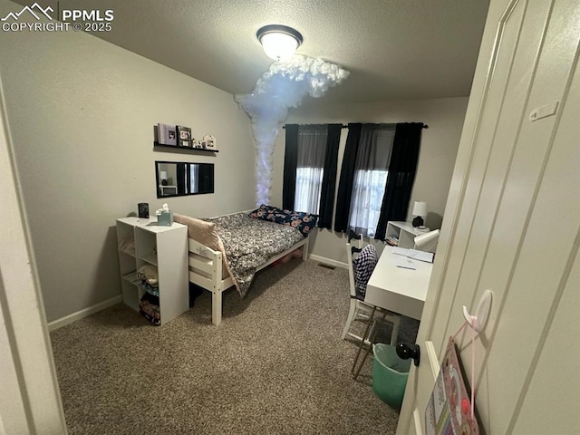 carpeted bedroom with baseboards and a textured ceiling