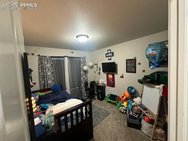 bedroom with carpet floors and a textured ceiling