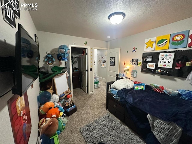 bedroom with a textured ceiling and carpet