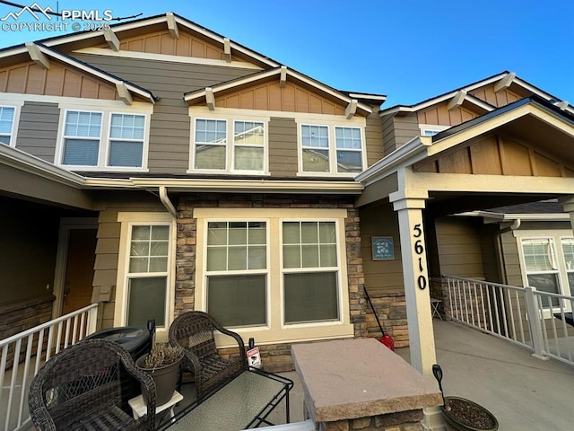 exterior space with stone siding and board and batten siding