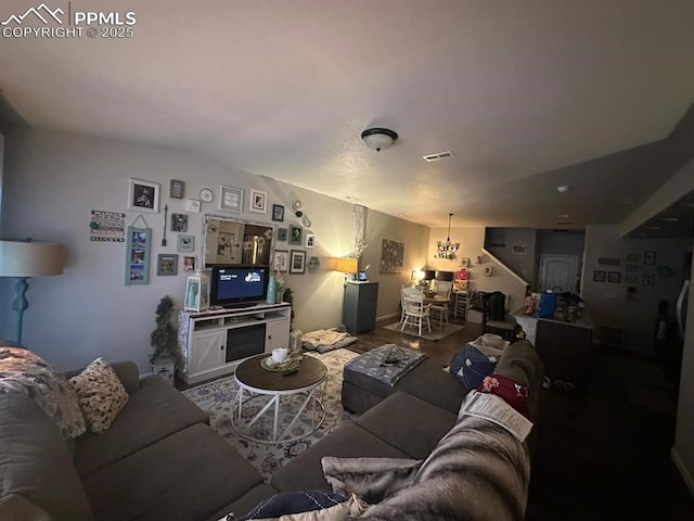 living room with wood finished floors and visible vents