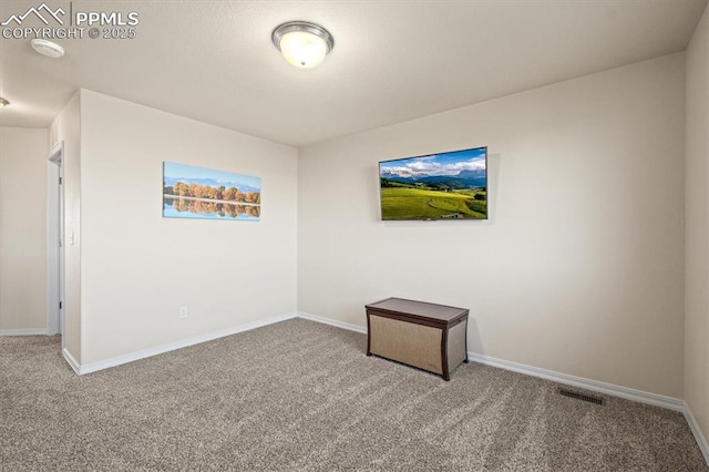 empty room featuring carpet floors, visible vents, and baseboards