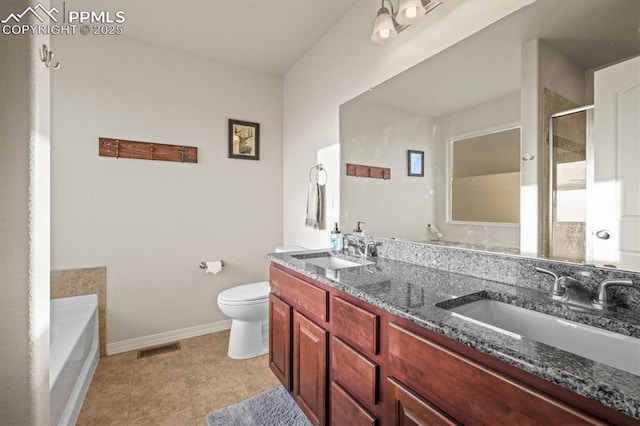 bathroom featuring toilet, a shower stall, visible vents, and a sink