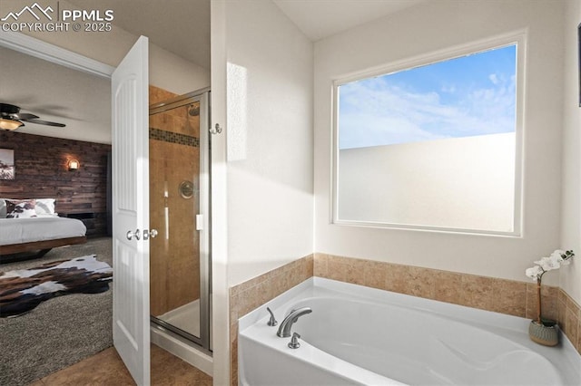 ensuite bathroom with a ceiling fan, a stall shower, a bath, and ensuite bathroom