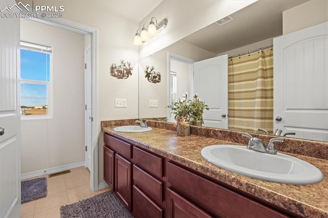 full bathroom featuring double vanity, visible vents, a sink, and tile patterned floors