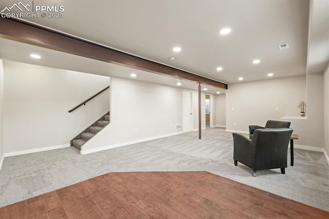 finished basement with stairs, baseboards, wood finished floors, and recessed lighting