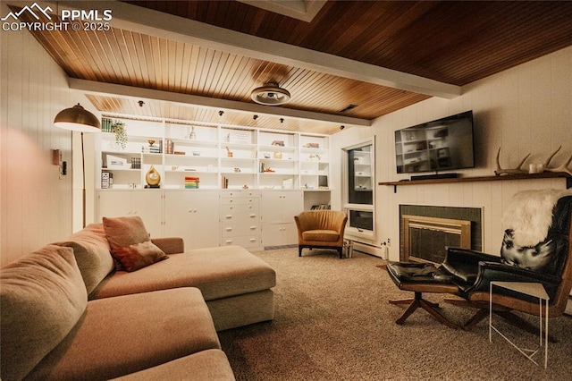 living area featuring built in shelves, carpet, a tiled fireplace, wood ceiling, and beamed ceiling