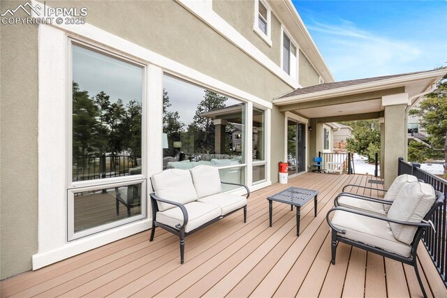 wooden terrace featuring an outdoor hangout area