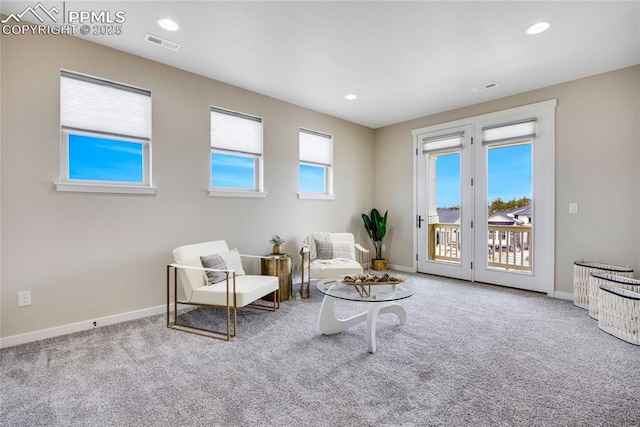 sitting room featuring carpet, visible vents, and baseboards