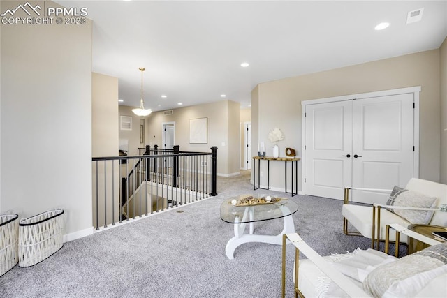 carpeted living room with visible vents, baseboards, and recessed lighting