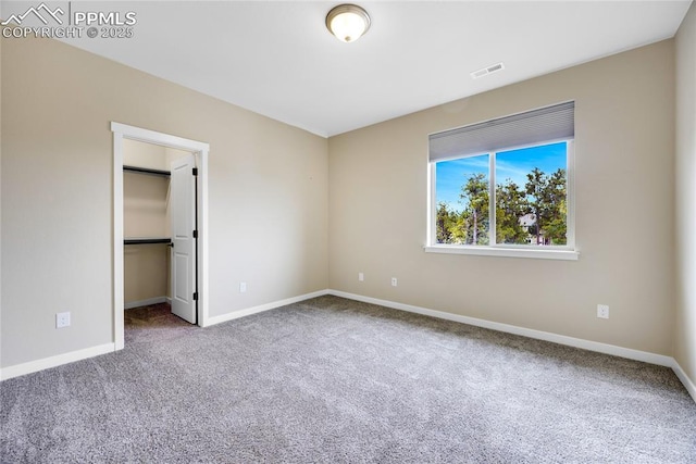 carpeted spare room with baseboards and visible vents