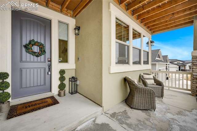 entrance to property featuring stucco siding