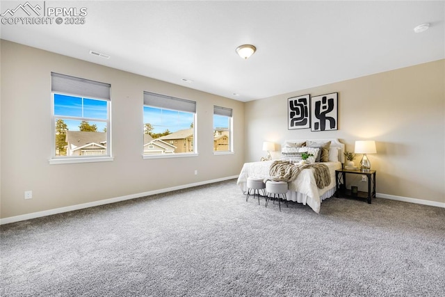 bedroom featuring carpet floors, visible vents, and baseboards