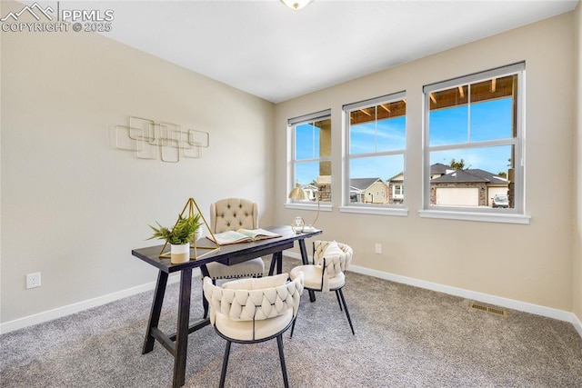 office area with carpet floors, visible vents, and baseboards